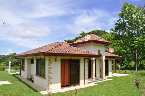 The front of the house features a beautiful garden and welcoming entrance