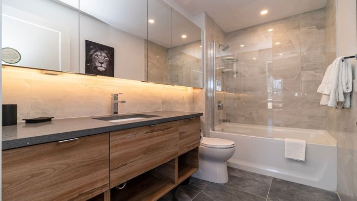 Recharge in the spacious bathroom, featuring a luxurious tub for a relaxing, spa-like experience.