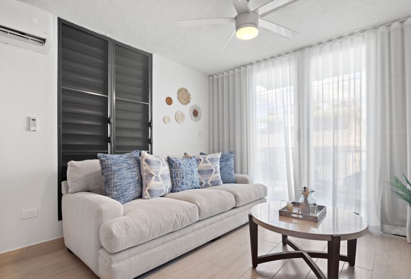 Our living room, designed for ultimate relaxation, features a plush sofa and soft throws.