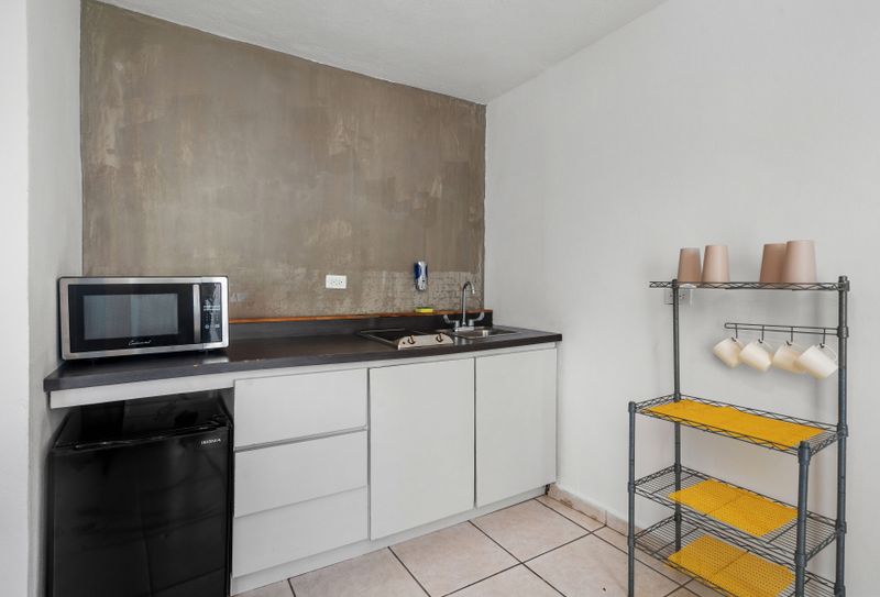 Discover tranquility and serenity in this contemporary kitchen, complete with a captivating view that adds to the ambiance of relaxation and peacefulness.