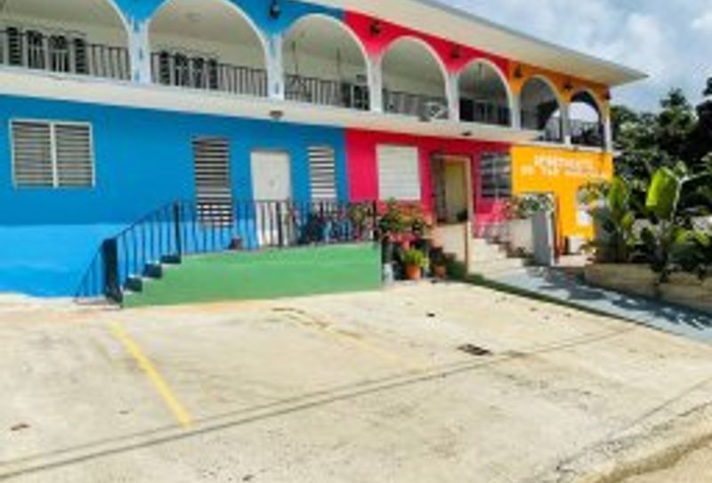 Experience vibrant living! Our beautifully maintained building boasts a cheerful exterior and ample outdoor space, perfect for enjoying the sunshine and fresh air.