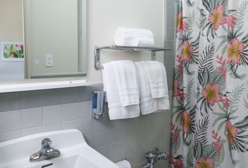 Refresh and rejuvenate in our immaculate bathroom, boasting fresh towels, essential toiletries, and a clean, spacious vanity for your convenience.