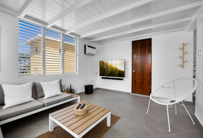 Kick back in the sun-filled lounge, featuring a soft sofa and large window – a perfect space to unwind, read a book, or binge your favorite series in comfort.