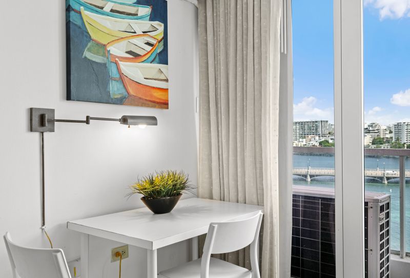 Work or dine comfortably at this well-lit table with captivating water and city views.