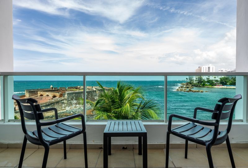 Condado | Oceanfront Apartment 3 Your private balcony with stunning views of the historic fort and sparkling ocean. Perfect for morning coffee!
