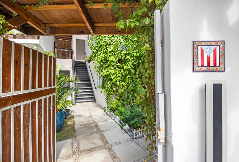 Discover the charming pathway leading to your private retreat, surrounded by lush greenery.