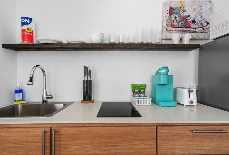 Prepare meals in this well-equipped kitchen with a refrigerator and microwave.
