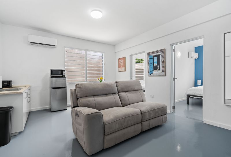 Feel at home in a space that combines comfort and style, featuring vibrant walls and cozy seating.