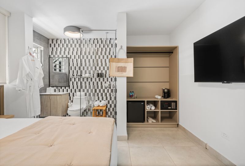 Enjoy the comforts of home in this stylish room, equipped with a comfortable bed, a modern bathroom, and a closet with a mini-fridge and coffee maker.