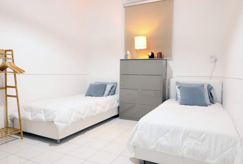 A cozy and inviting bedroom with two comfortable beds, perfect for sharing with friends or family.