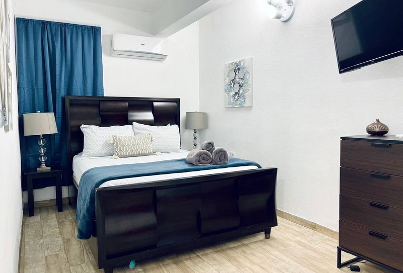Experience restful nights in our comfortable main bedroom, boasting a plush queen-size bed and a powerful air conditioner to keep you cool and relaxed.