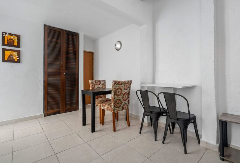 Relax in a space that boasts modern furniture, including comfortable patterned chairs and sleek black dining table.  It’s perfect for preparing simple meals and snacks during  your stay.