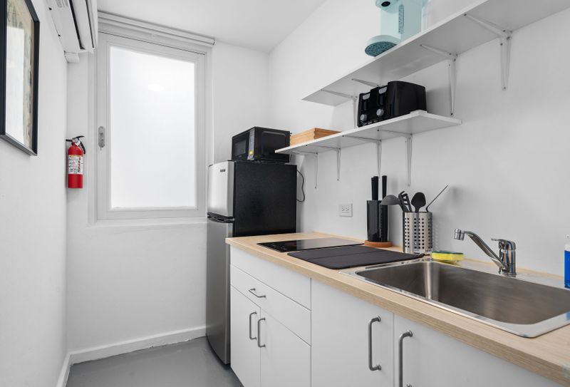 Enjoy the convenience of our cozy kitchenette, complete with modern appliances for city living.
