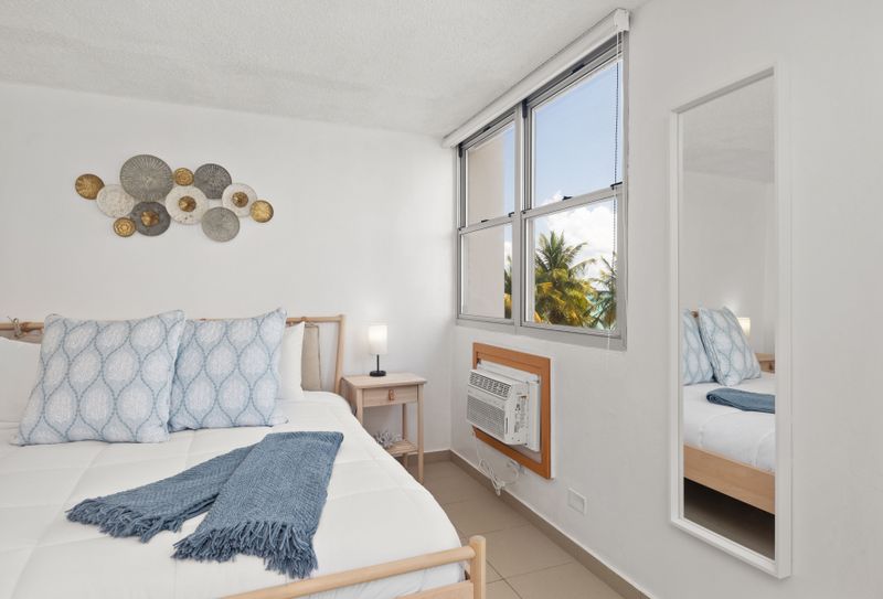 beachfront room with beach views, bed and wall art