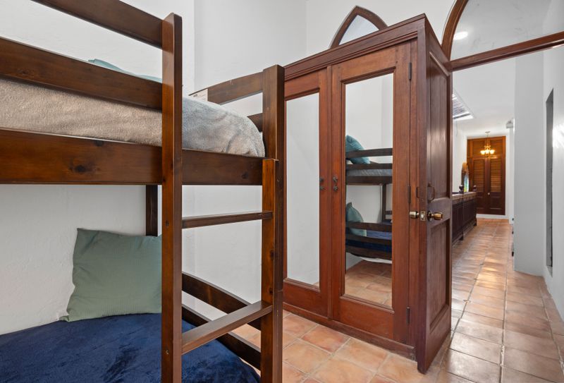 An inviting guest room featuring distinctive bunk beds, perfectly combining functionality with modern style.