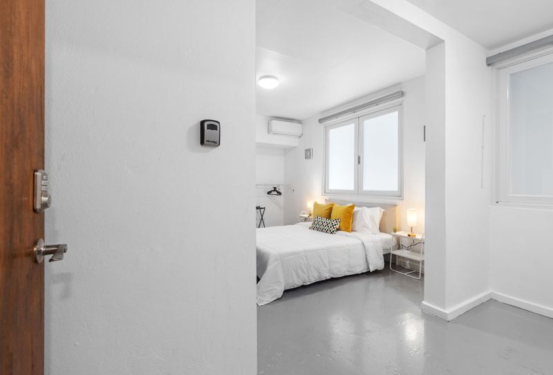 Condado | Family Vacation Rental 5 Bright Beginnings: Step into this airy and welcoming bedroom, where clean white lines and natural light create a refreshing and peaceful atmosphere.