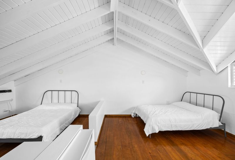 Rincón | Stay With Balcony 3 This bright and clean bedroom features twin beds, perfect for a restful night's sleep.