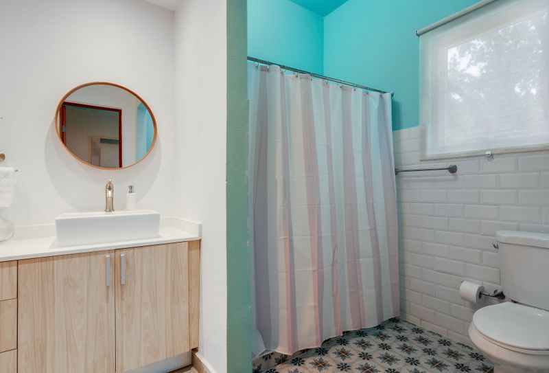 A clean bathroom with a big mirror, perfect for getting ready.