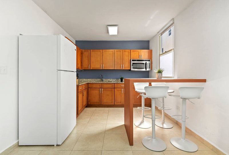 Cook with confidence! Our well-equipped kitchen features beautiful wooden cabinets and modern appliances, ready for all your culinary needs.