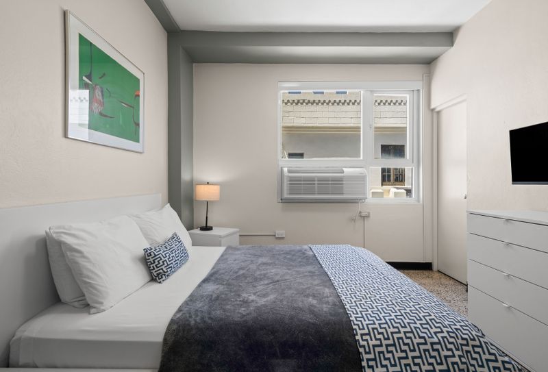 Step into your peaceful escape! This bright bedroom offers a comfortable queen bed, modern amenities, and a soothing atmosphere perfect for unwinding after a busy day.