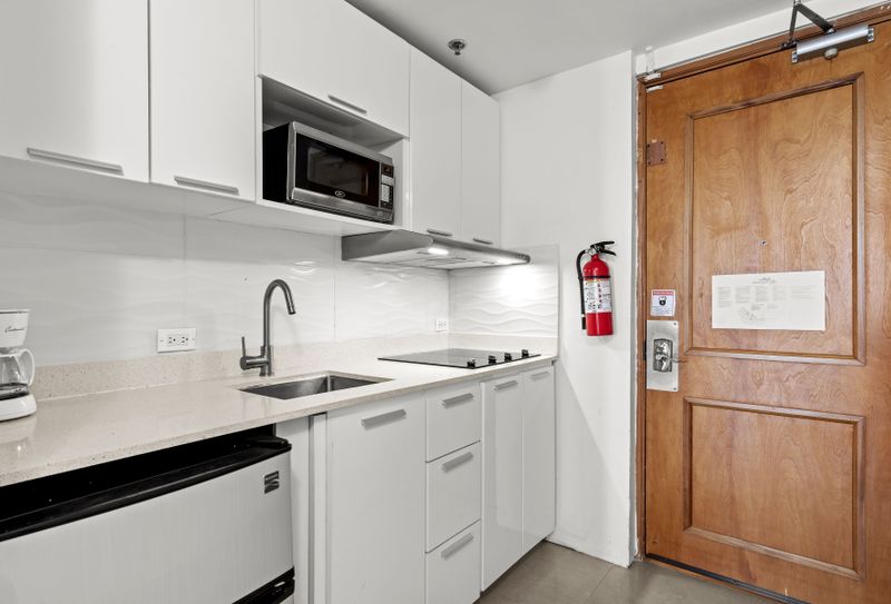 Sleek, modern kitchenette with all essentials, perfect for convenient meal prep during your stay.