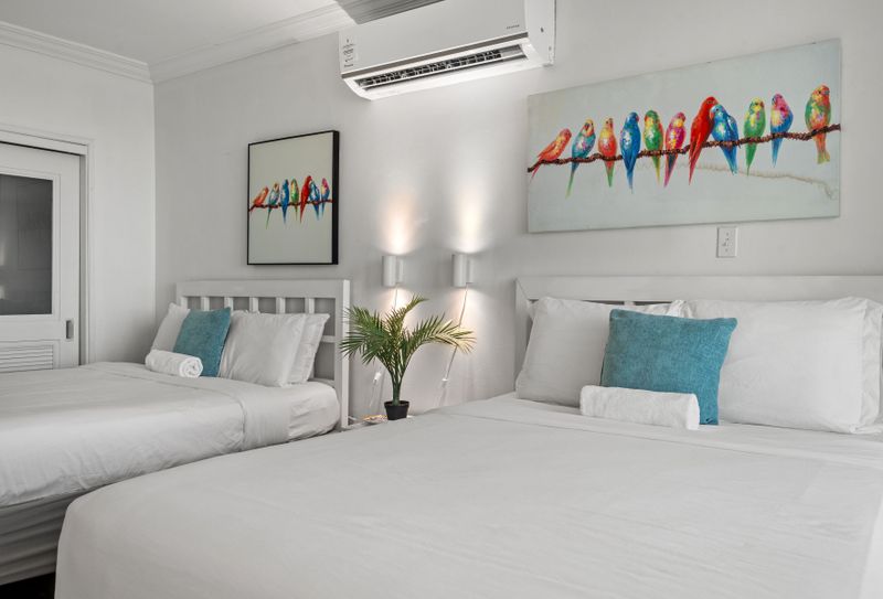 Sleep soundly in this comfortable bedroom with two perfectly arranged beds. Delightful artwork and soft lighting ensure a restful stay.