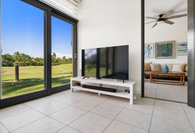 Unwind in this bright and stylish living space, featuring a stunning view and a sleek TV for your entertainment.