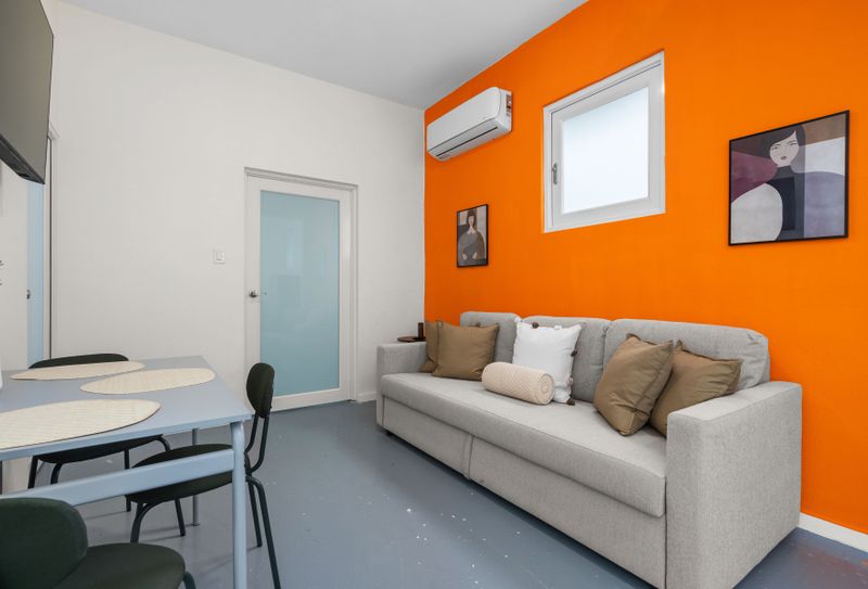 Bright living area with inviting seating, flat-screen TV for movie nights, and a coffee table for snacks or drinks.