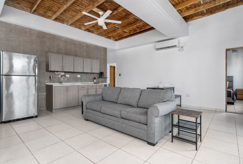 The bright and spacious living room flows effortlessly into a contemporary kitchen, making it an ideal space for entertaining!