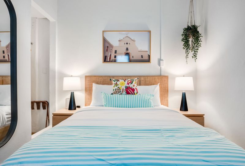 A pleasant chamber for rest, with a tasteful wall mural and a spacious reflection.