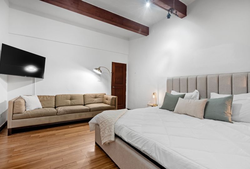 Experience luxury with our room’s sleek flat-screen TV and rich wooden decor.