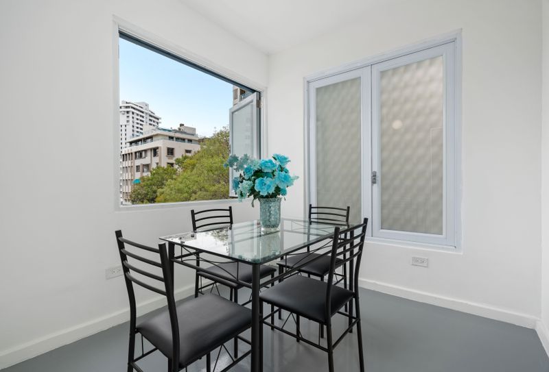 Enjoy city views through the expansive window as you dine in style.