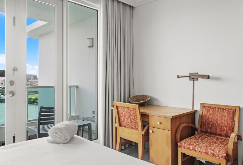 Cozy workstation by the balcony doors, offering a perfect blend of work and views.