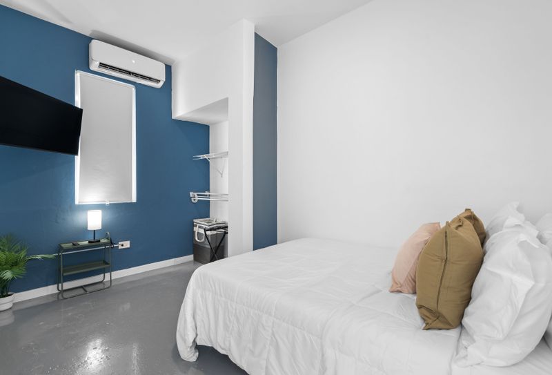 Unwind in our Cozy and Modern Bedroom with air conditioning, perfect for a relaxing retreat.