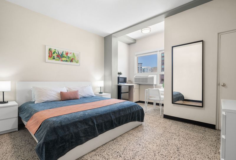 Discover a comfortable and practical setup, featuring a cozy bed and essential amenities nearby, ensuring a convenient and enjoyable stay.