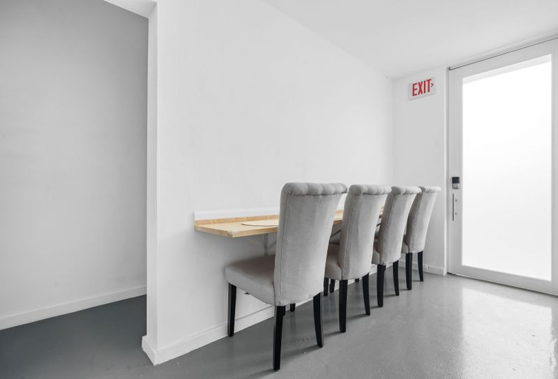 Dine in style with our minimalist dining space, featuring sleek grey chairs and a natural wood table.