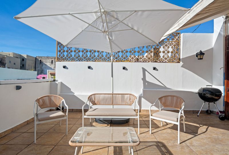This inviting outdoor space is perfect for enjoying a cup of coffee in the morning.