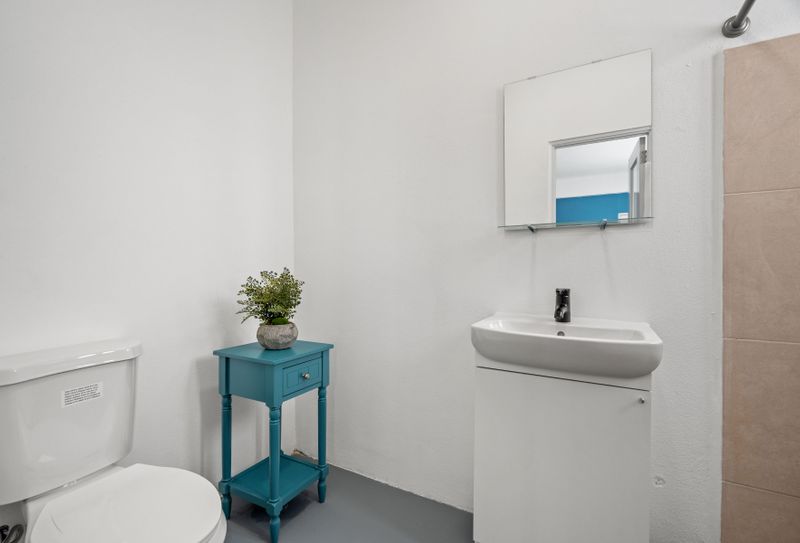 A bathroom oasis awaits, boasting sleek surfaces and neutral tones.