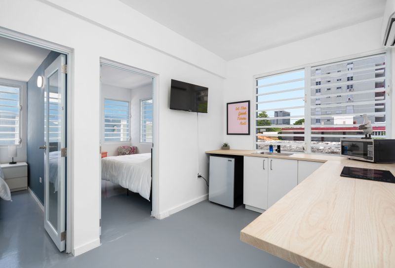 Condado | Near The Beach Condo 3 The juxtaposition of modern interiors with views of natural greenery offers guests a serene yet contemporary living experience.