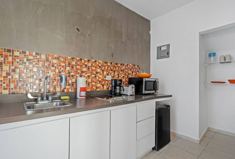 The modern appliances and clean, bright space make cooking a breeze. The colorful backsplash and modern appliances create a bright and cheerful atmosphere that is perfect for cooking and entertaining.