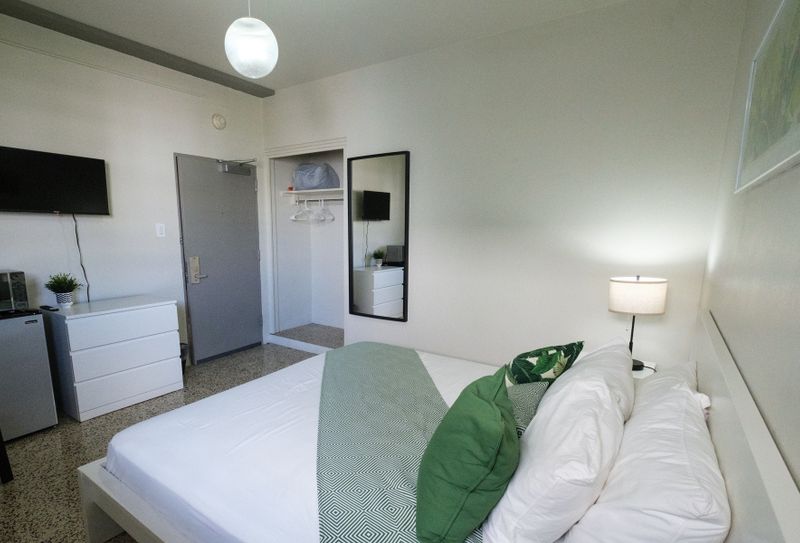 Discover a blend of modern style and cozy comfort in this inviting bedroom, featuring a plush bed and ample space to make yourself at home.