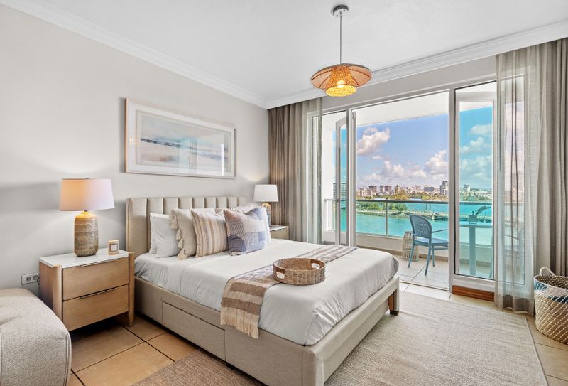 Dreamy bedroom with stunning ocean views and direct balcony access. Relax & unwind!