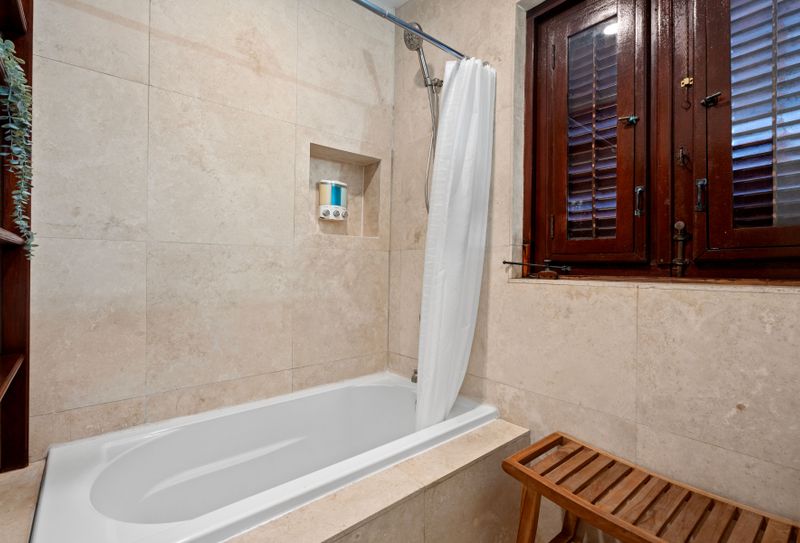 This tranquil bathroom, complete with a soothing bathtub, is the perfect place to relax and unwind after a long day.