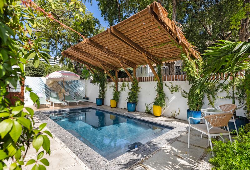 huge  refreshing pool with sunbathing beds and chairs, terrace with gazebo