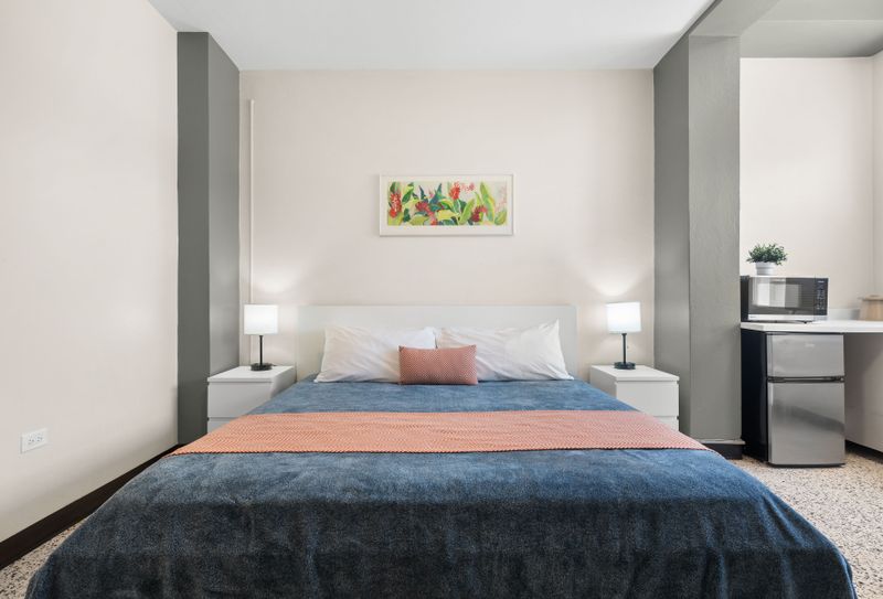 Step into comfort and relaxation! This bright and inviting bedroom offers a plush bed and ample space to unwind after a day of exploring.