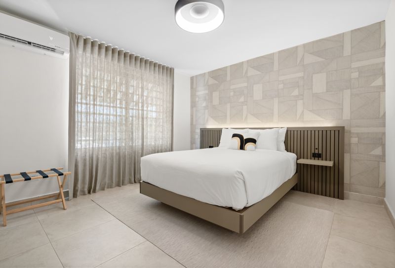 Retreat to this serene bedroom and unwind on the plush queen-sized bed, surrounded by calming decor and plenty of natural light.