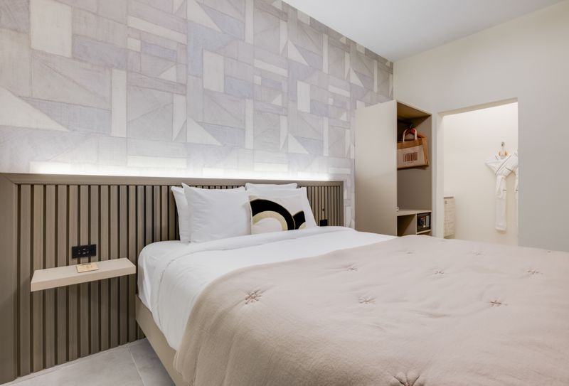 Retreat to this serene bedroom and unwind on the plush bed, surrounded by calming decor and plenty of natural light.