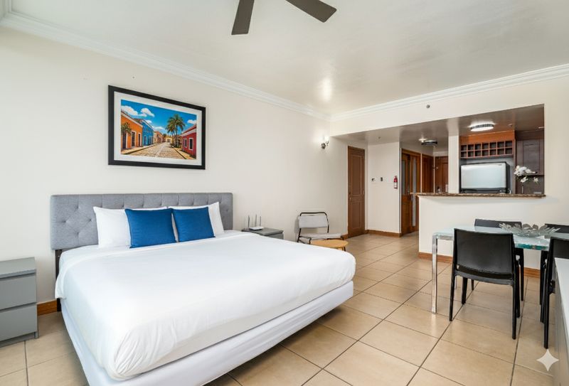 Condado | Oceanfront Apartment 2 Dreamy Puerto Rico art! Experience the island charm right from your stylish bedroom.