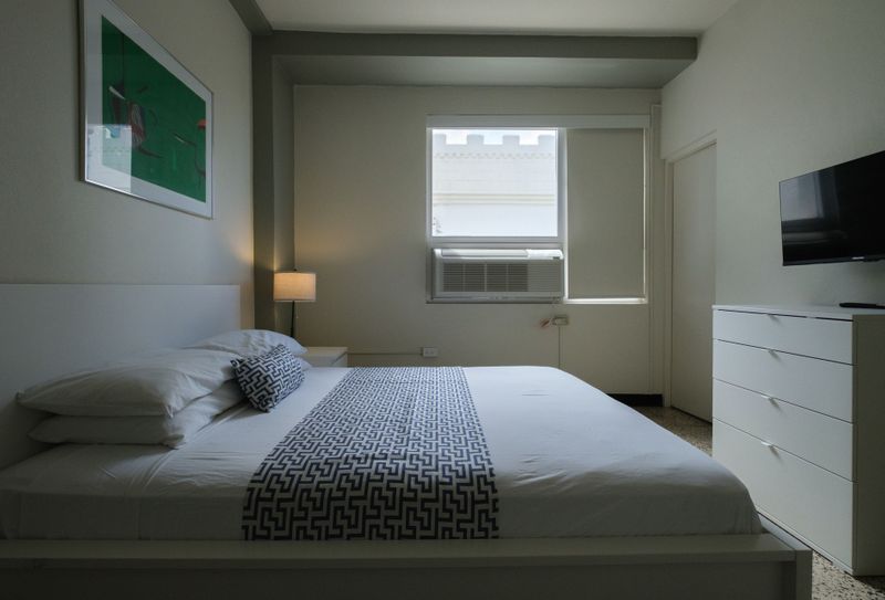 Fresh and functional! This modern bedroom boasts a comfortable queen bed with stylish bedding, providing a chic yet relaxing space for your stay.