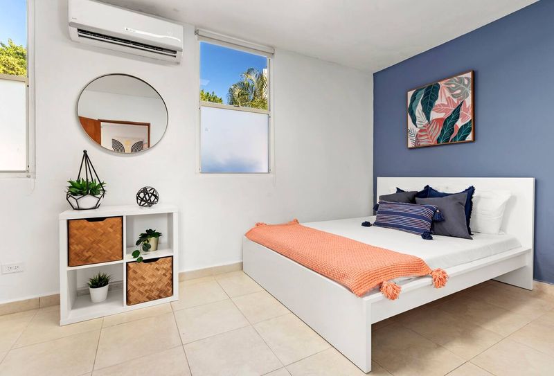 Find tranquility in this modern bedroom. The stylish teal accent wall and comfortable bed create a peaceful and relaxing retreat for a perfect night's sleep